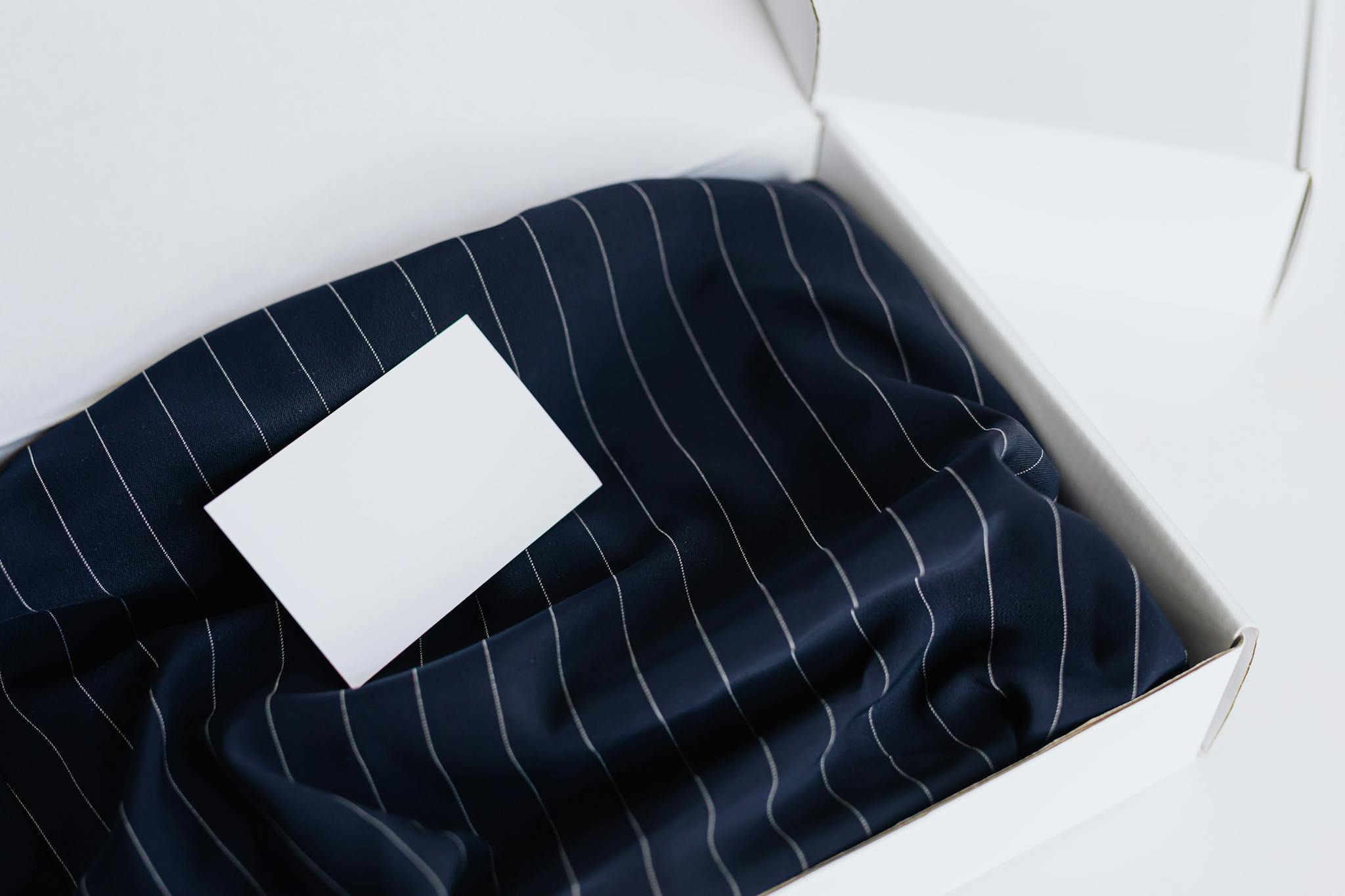 A sleek business card on luxurious silk fabric in an elegant box, perfect for mockup displays.